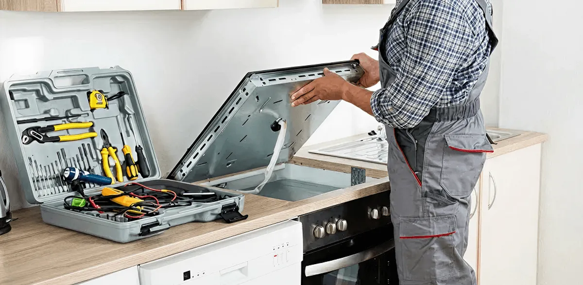 Handyman repairing a cooktop and checking wiring connections in Oklahoma City, OK