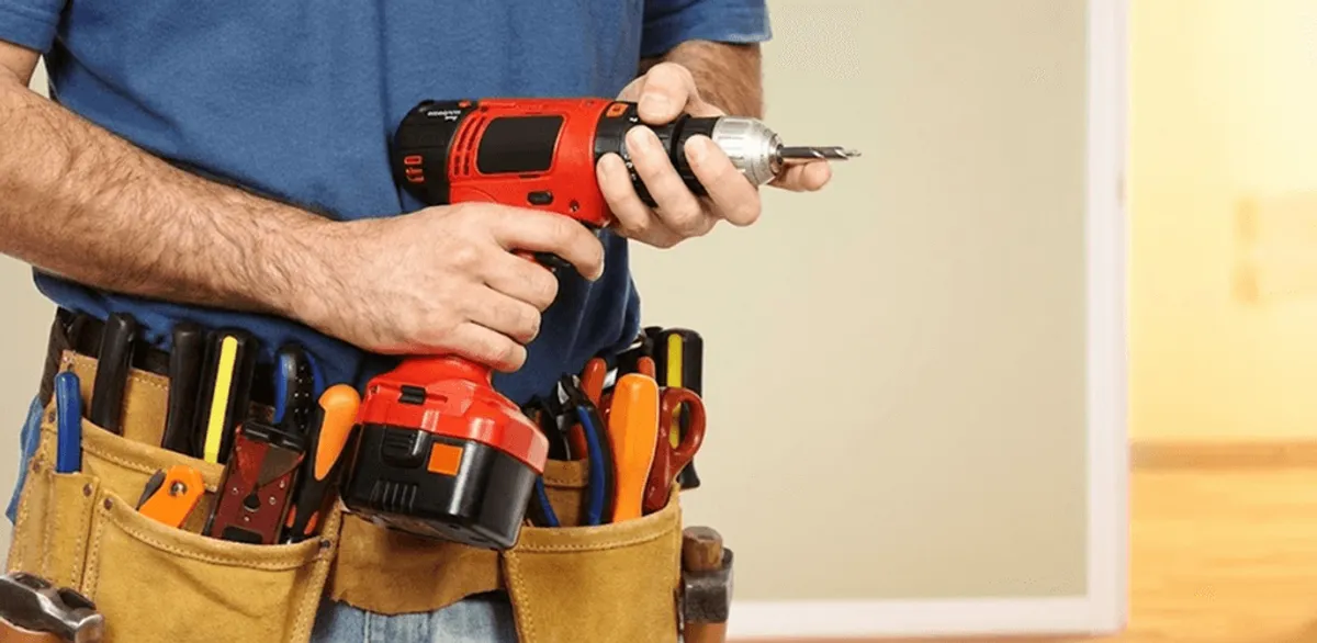 Handyman holding a power drill for home repairs and installations in Oklahoma City, OK